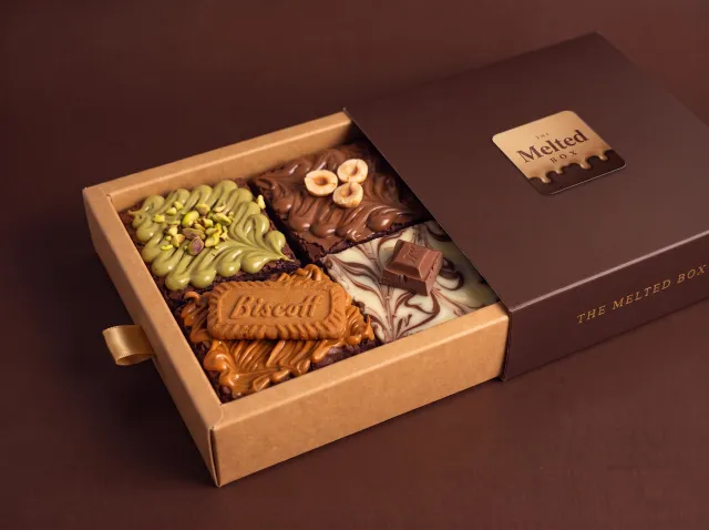 Box of 4 in The Melted Box gift box with pistachio, hazelnut, Biscoff and white chocolate marble brownies